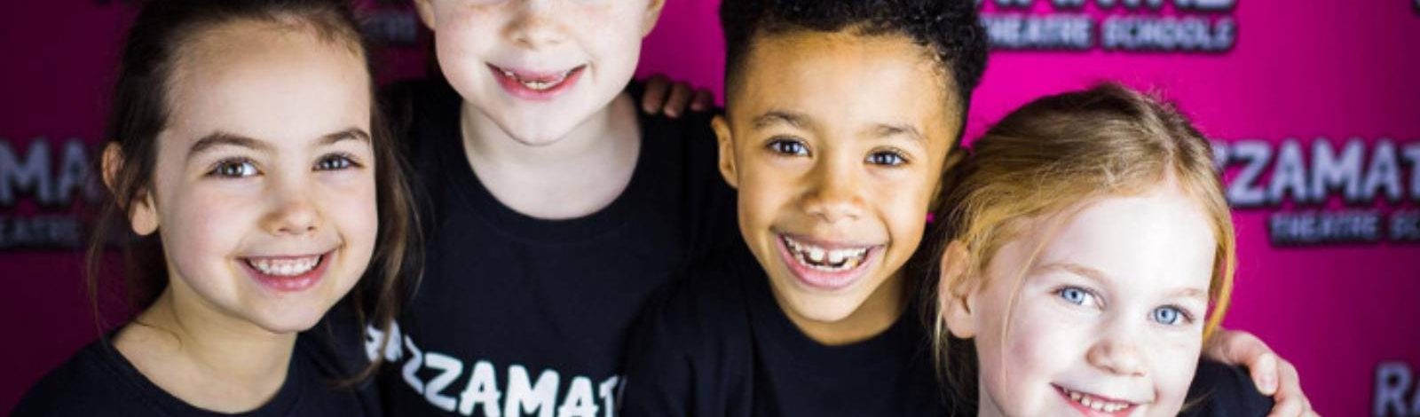 Children smiling at Razzamataz Theatre Schools