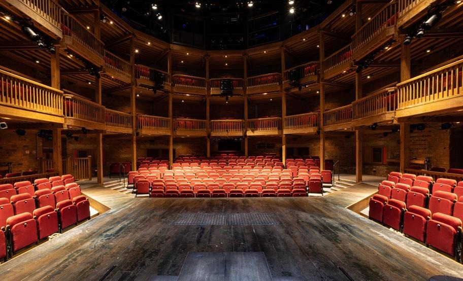 A view of the Theatre of the World installation in London, showcasing a globe surrounded by theatrical elements and art