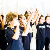 Children dancing, wearing black T-shirts