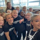 Kids smiling in a group selfie