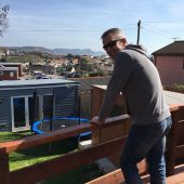 Man on deck enjoying scenic suburban view