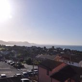 Coastal town view with ocean and hills