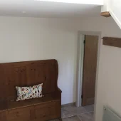 Wooden bench with cushion in cozy hallway