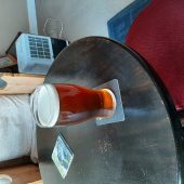 A pint of beer on a round table in a room