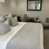 Modern cozy bedroom with gray bedding