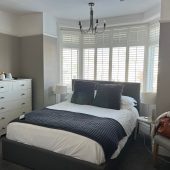 Cozy bedroom with window shutters