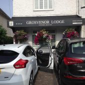 Guest house entrance with parked cars