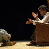 Two men in deep conversation on stage