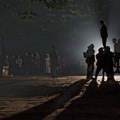 Street performers in dramatic lighting