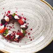 Berry-topped dessert on decorative plate