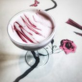 Elegant cocktail with red swirls and rose design
