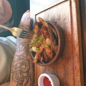 Tasty dish with herbs and sauce on a table