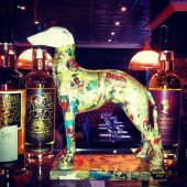 Decorative dog statue with whiskey bottles