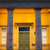 Illuminated building entrance with columns