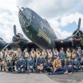 WWII bomber crew posing with aircraft